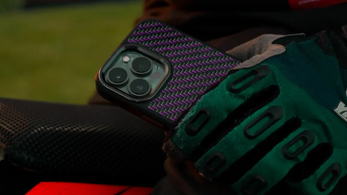 motocross rider holding a carbon fiber phone case