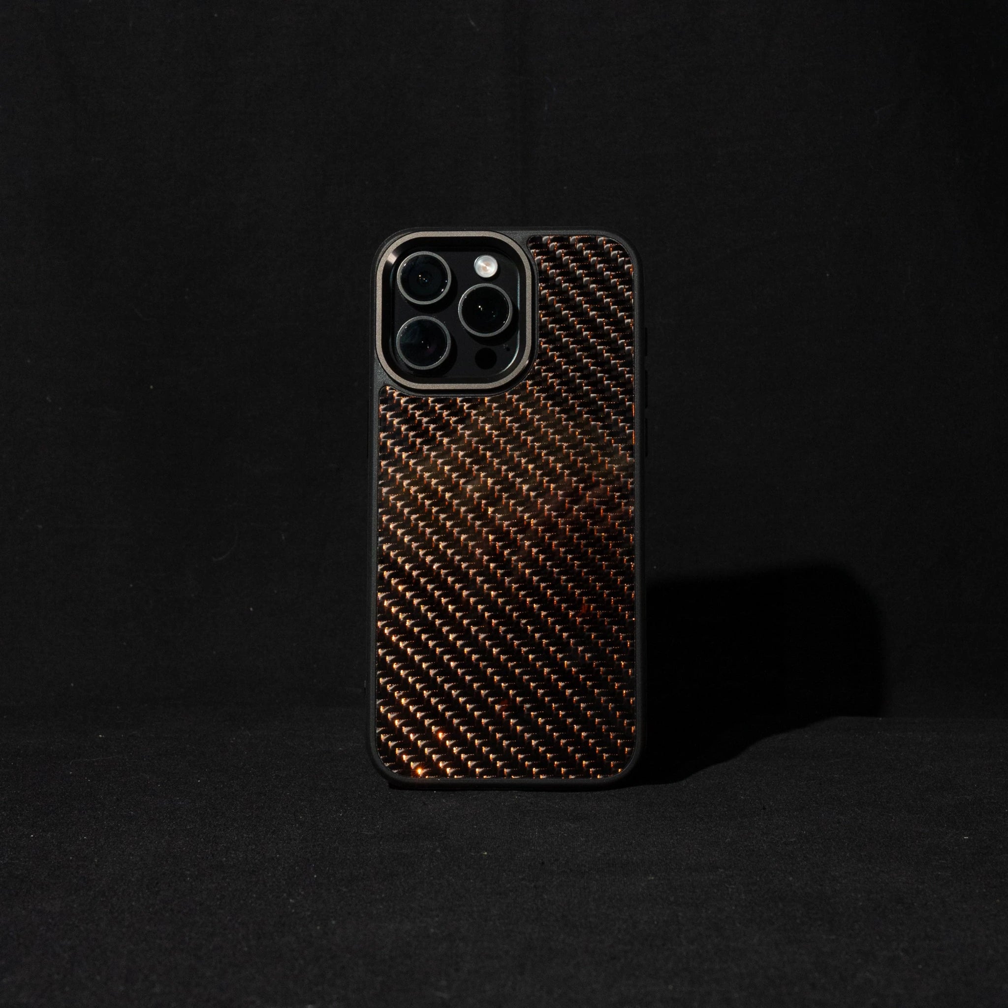 orange reflective Carbon fiber phone case on a black background