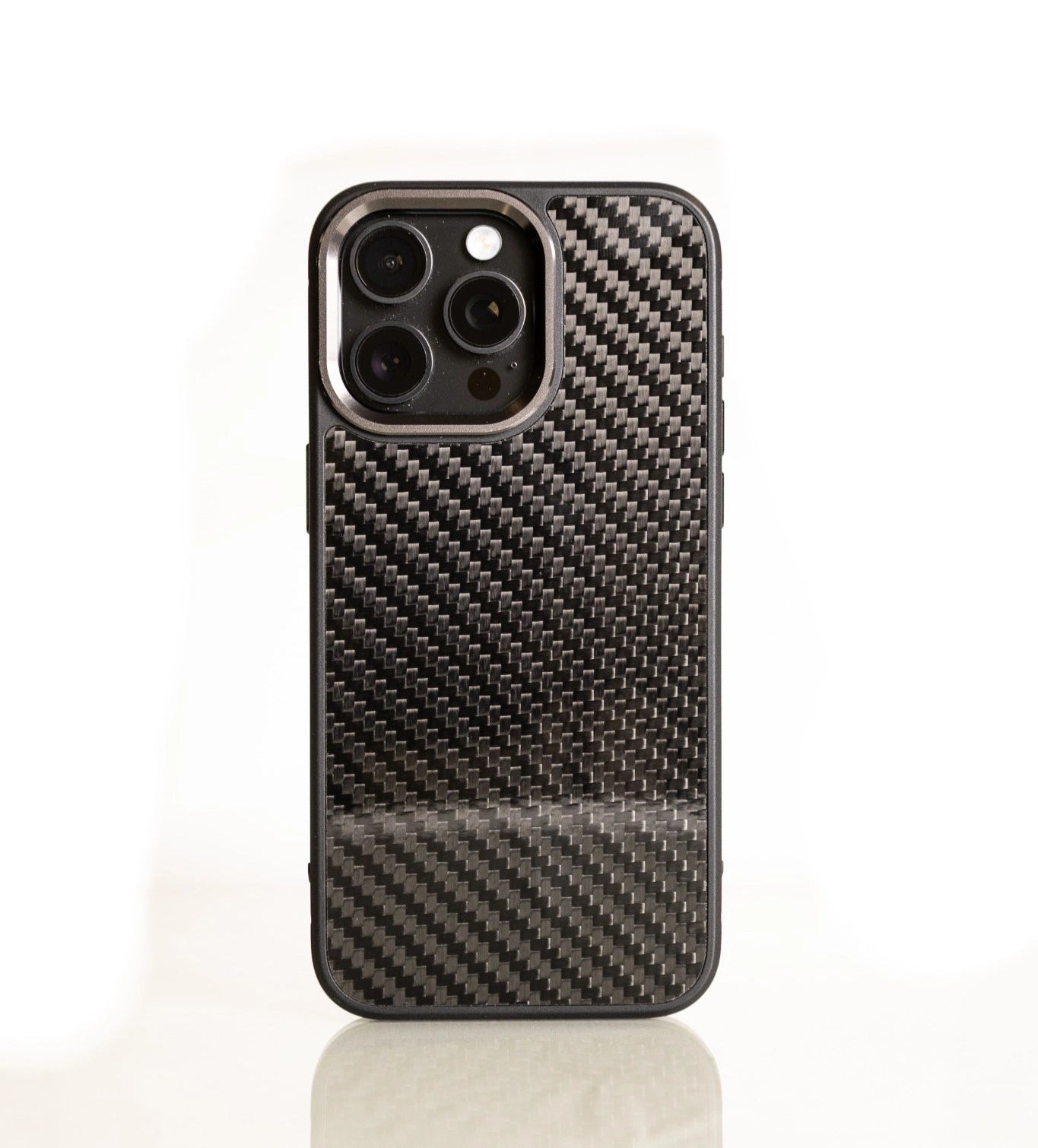 Black carbon fiber phone case with reflective 3D weave pattern, shown upright on a glossy surface.
