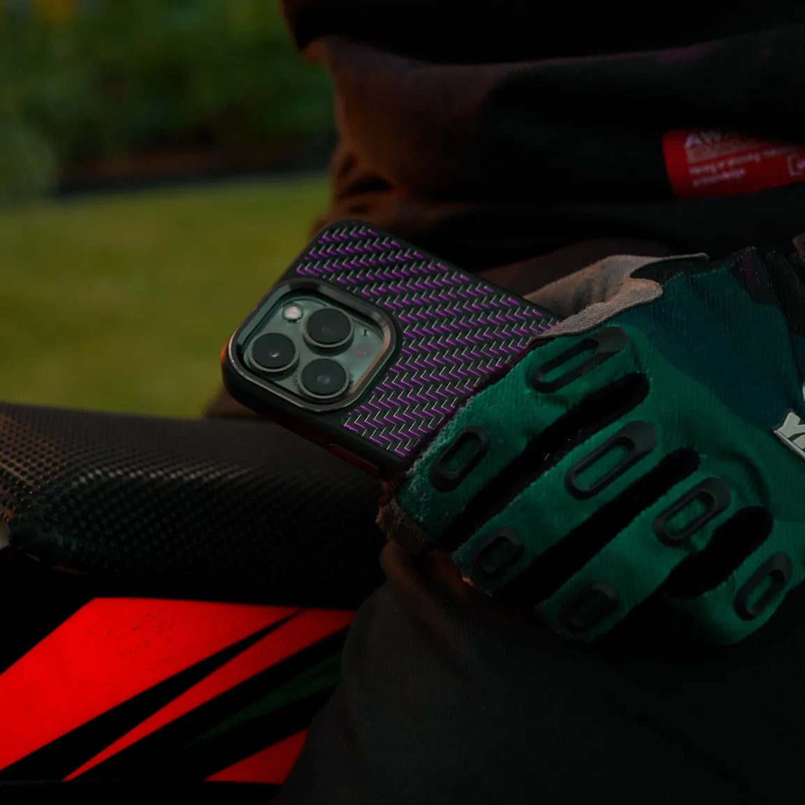 motocross rider holding a carbon fiber phone case