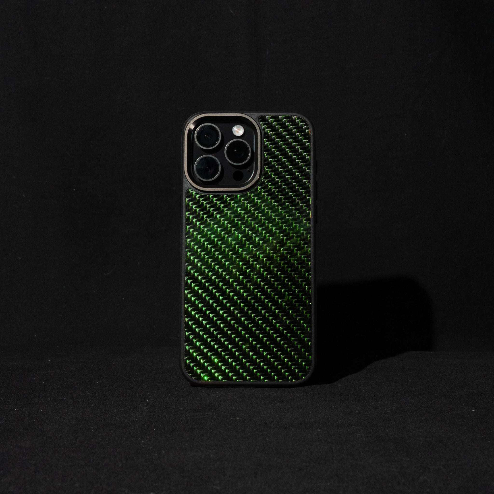 Green carbon fiber phone case on a black background

