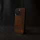 Orange carbon fiber phone case on a black background angled sideways

