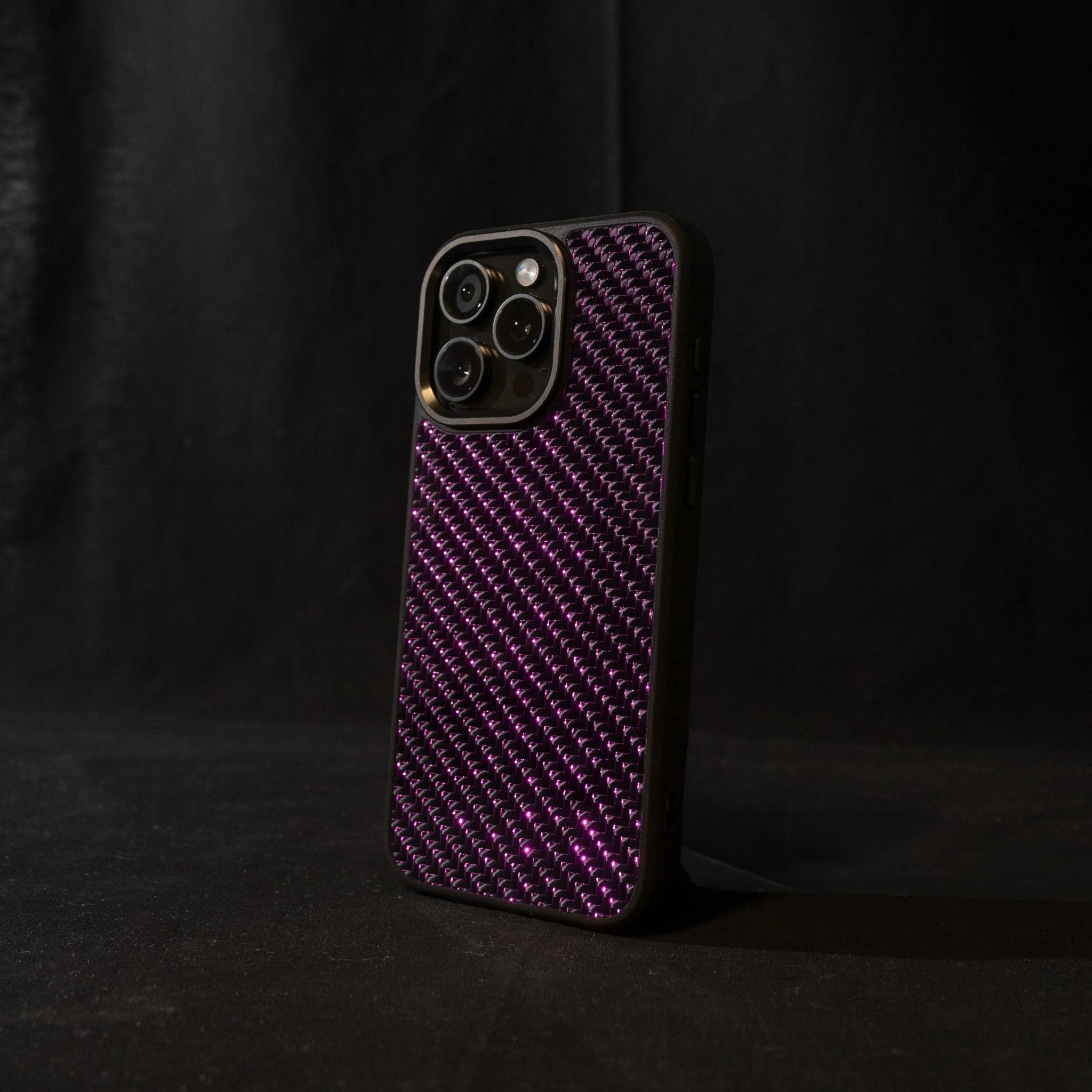 Purple carbon fiber phone case on a black background angled sideways