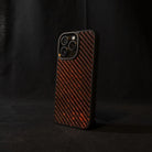 Red carbon fiber phone case on a black background angled sideways